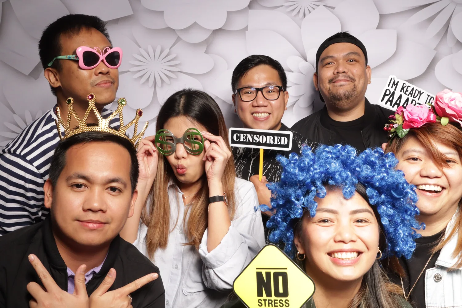 A group of guests posing with photo booth props