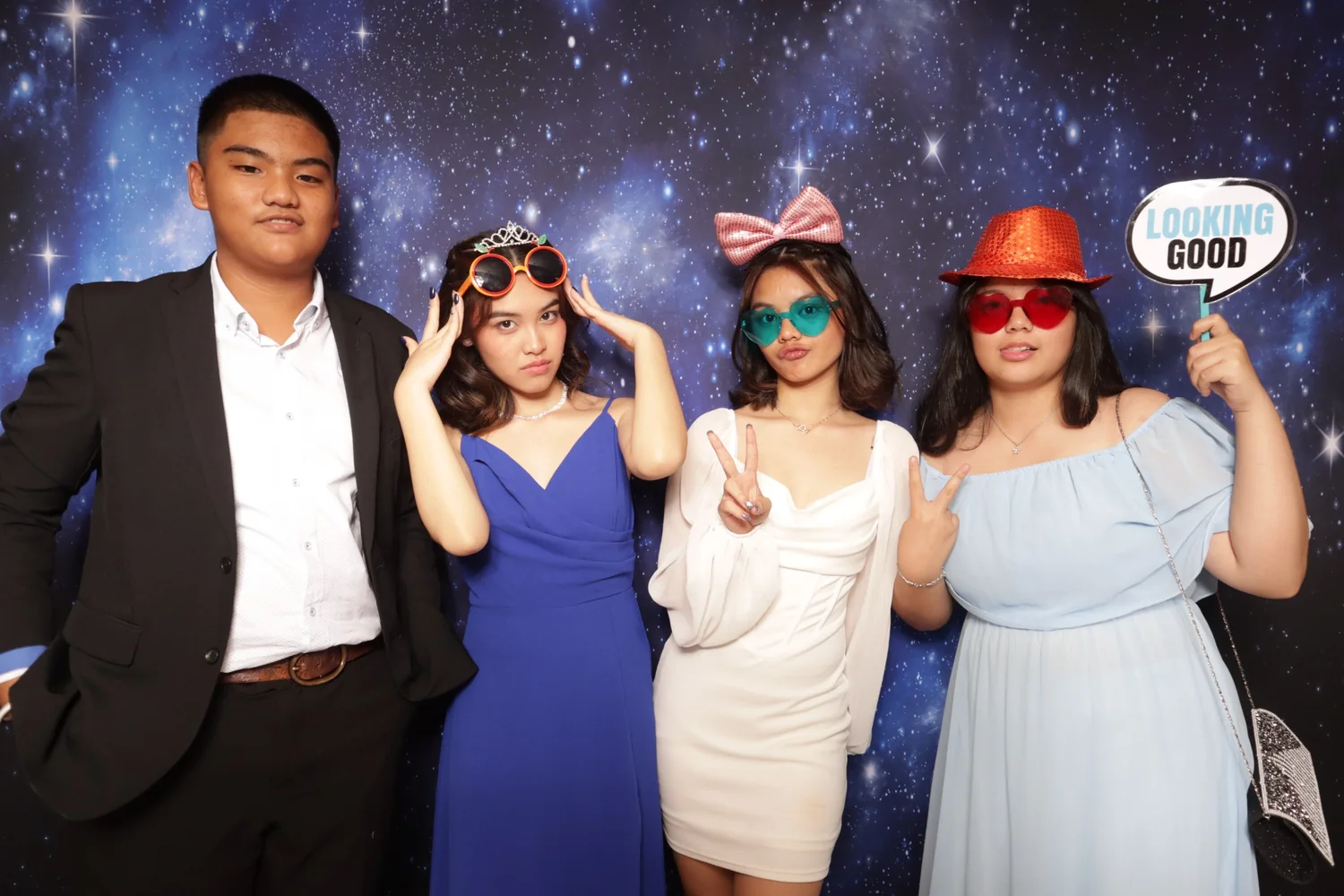 Guests enjoying a photo booth with a galaxy backdrop